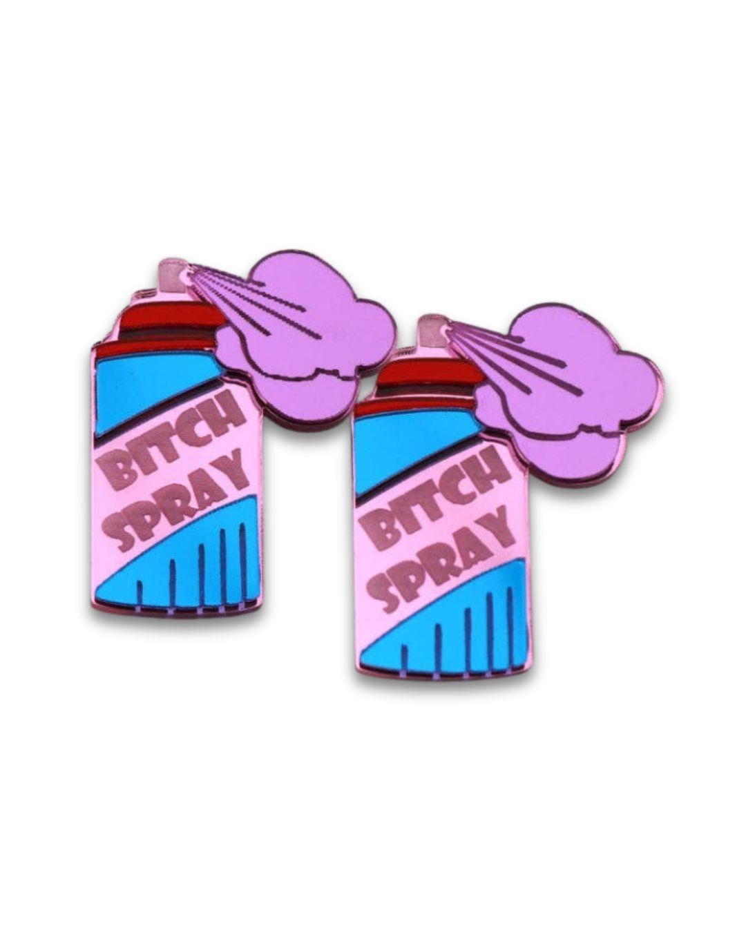 Acrylic stud earrings shaped like 'Bitch Spray' cans on a white background