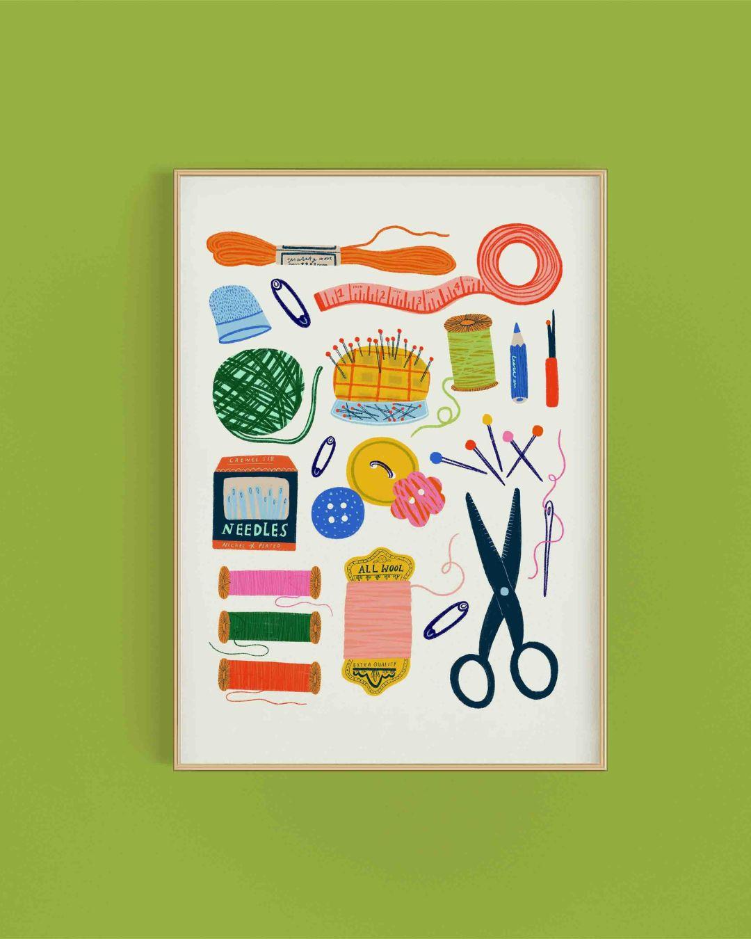 Framed illustration of sewing tools on a green background