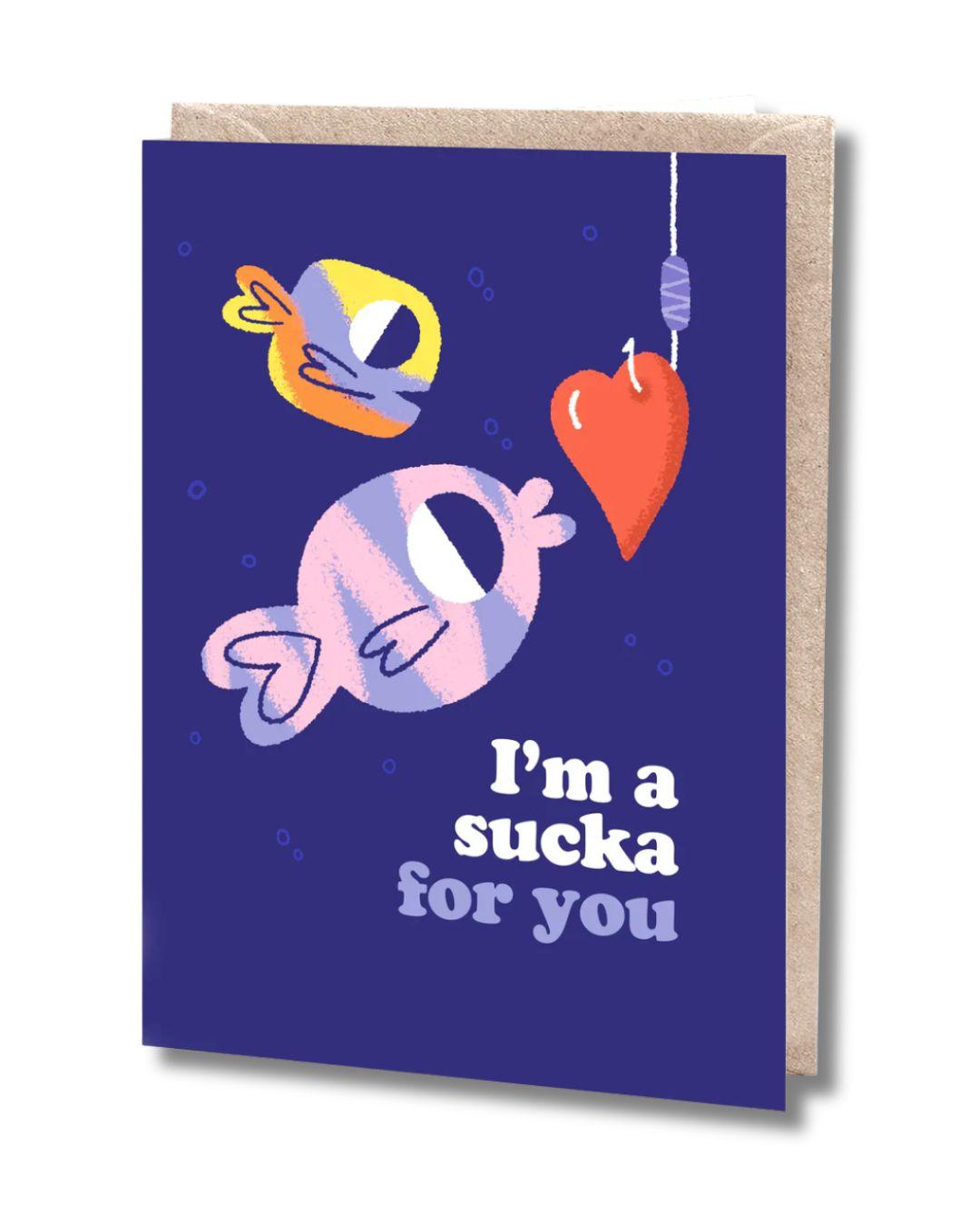 Greeting card with cartoon fish and heart on a blue background