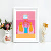 Framed artwork with two cats, a woman, and 'home sweet home' text on a pink background.
