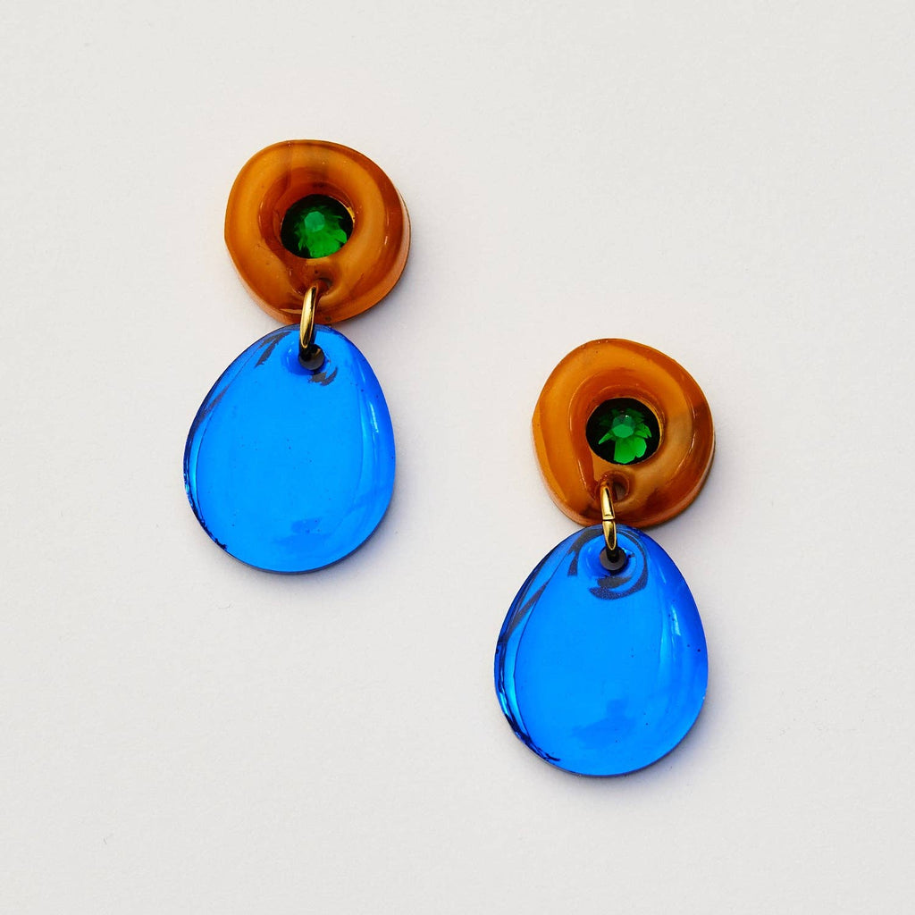 Pair of earrings with blue teardrop-shaped pendants and amber circular tops on a white background