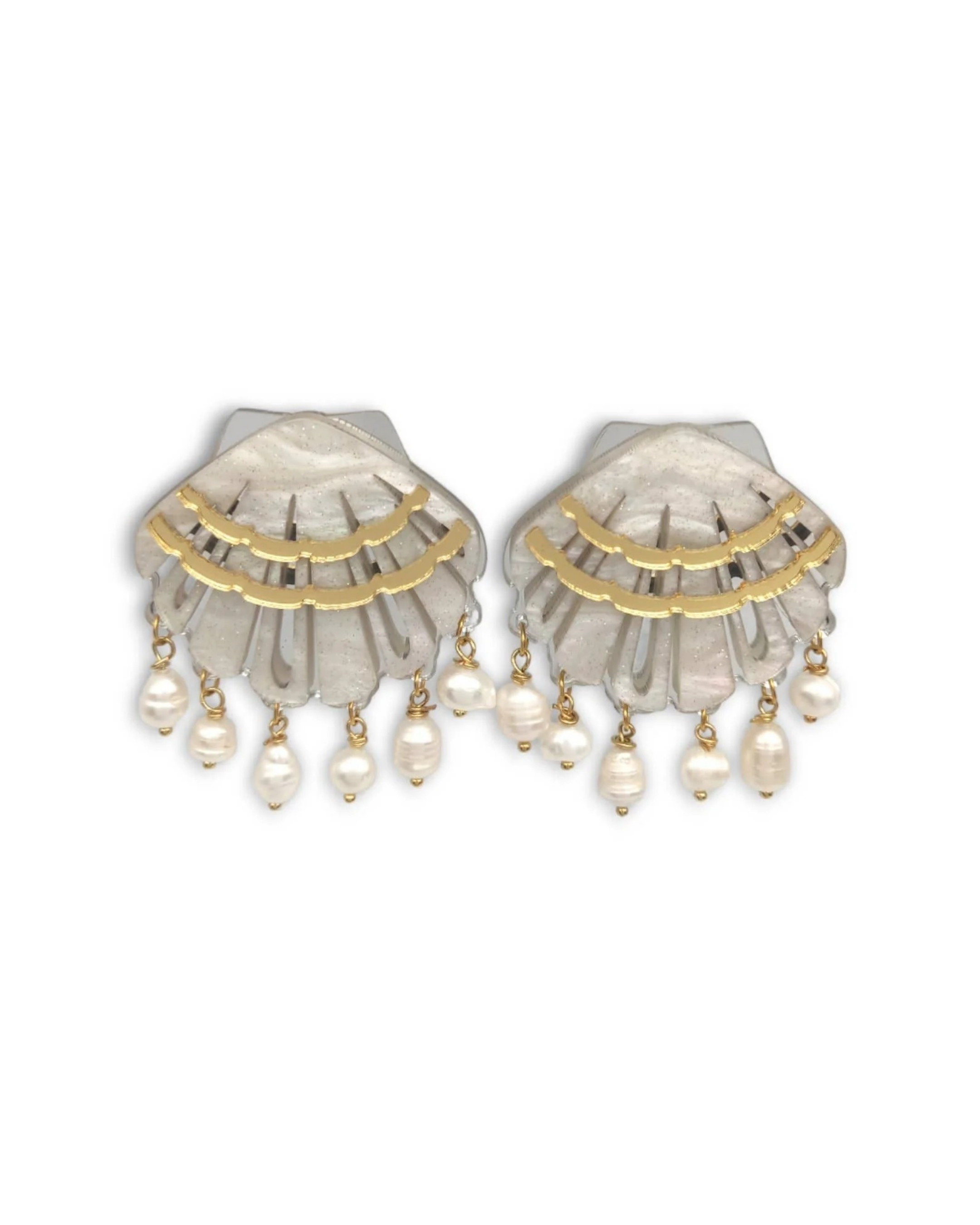 Pair of shell earrings with gold accents and pearl drops on a white background
