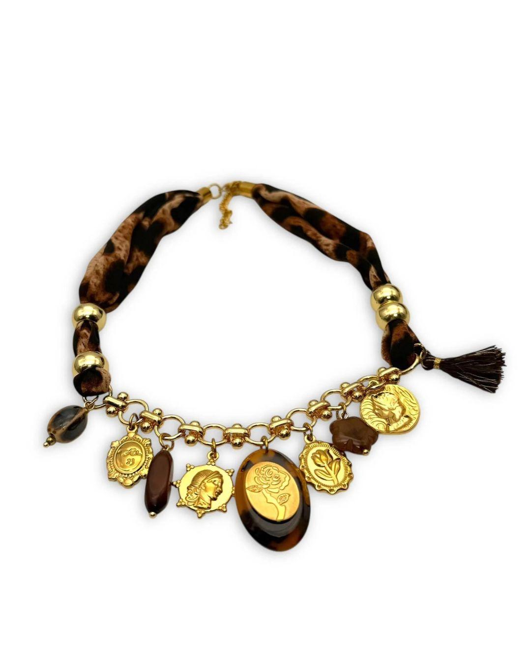 Necklace with animal print fabric and gold charms on a white background