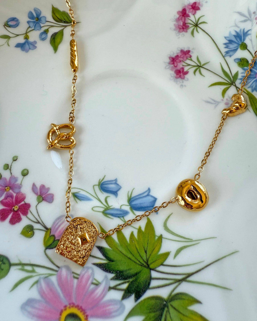 Gold necklace on a bread charms