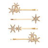 Set of gold hair pins with star designs on a white background