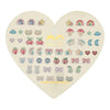 Heart-shaped box of various small earrings on a white background