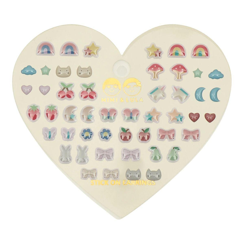 Heart-shaped box of various small earrings on a white background