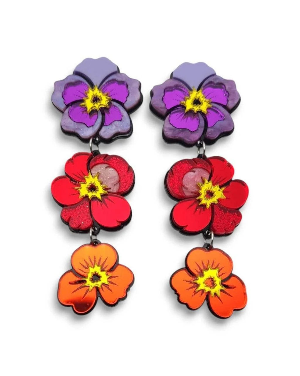 Colorful flower-shaped earrings on a white background