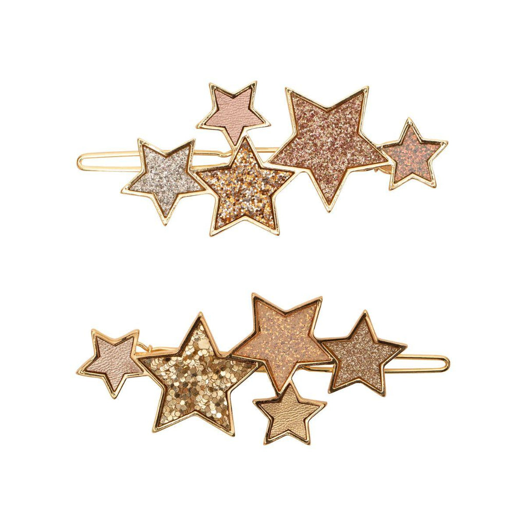 Set of star-shaped hair clips in gold, rose gold, and silver on a white background