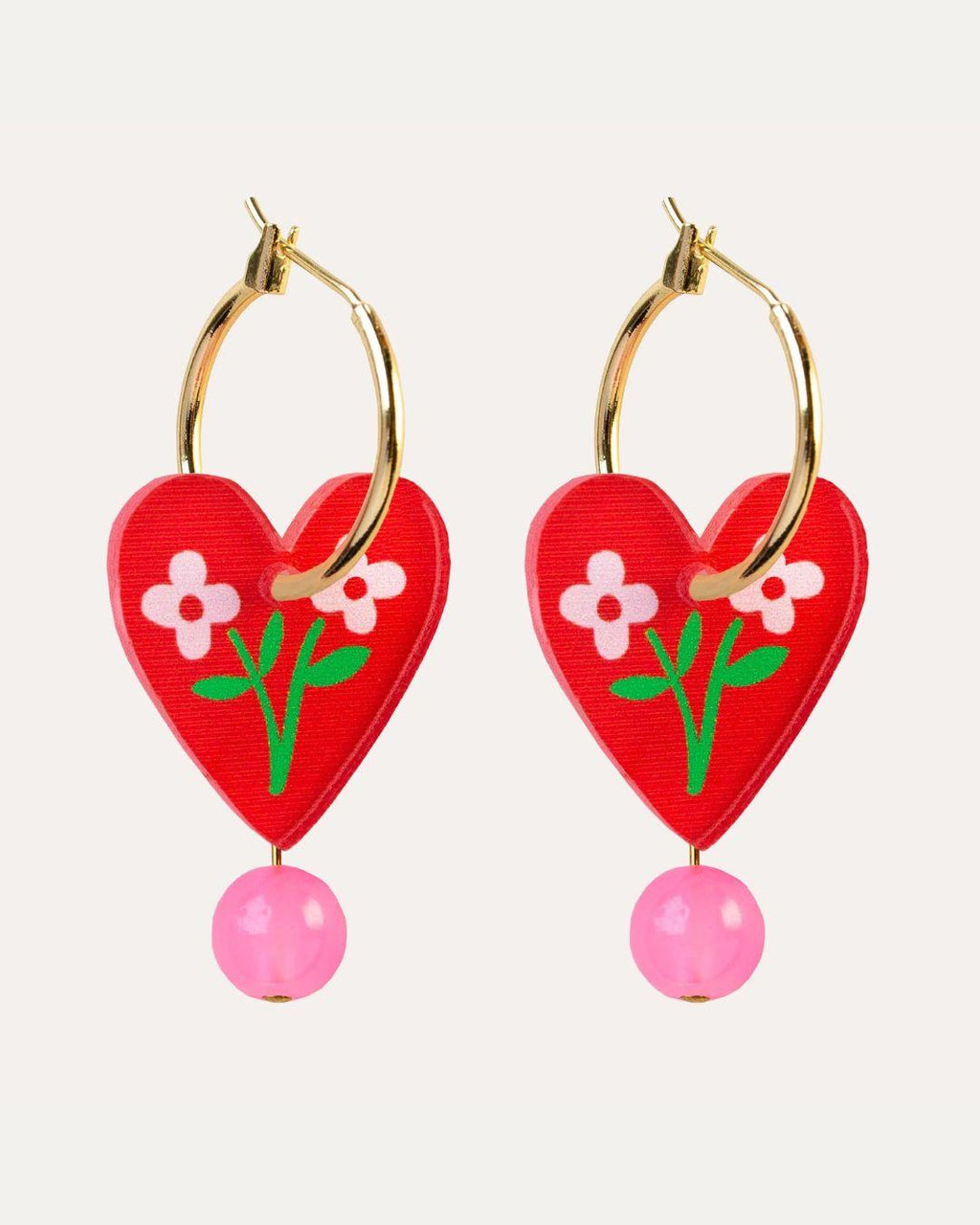 Heart-shaped earrings with floral design and pink beads on a white background