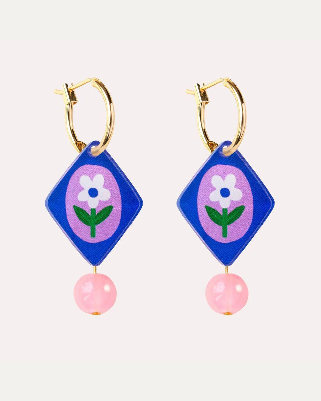 Hoop earrings with blue diamond-shaped pendants featuring a white flower and pink beads on a white background