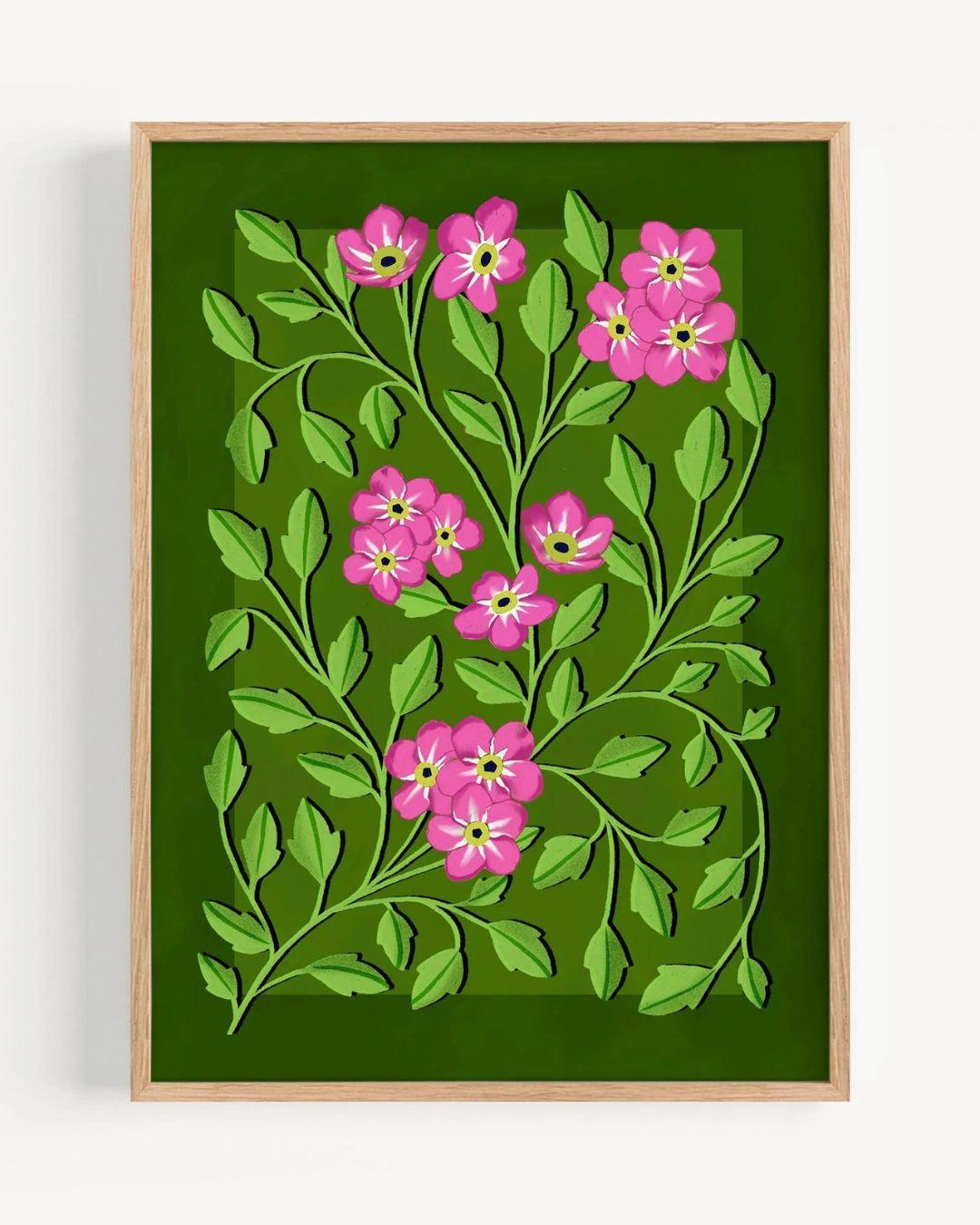 Framed artwork with pink flowers and green leaves on a green background