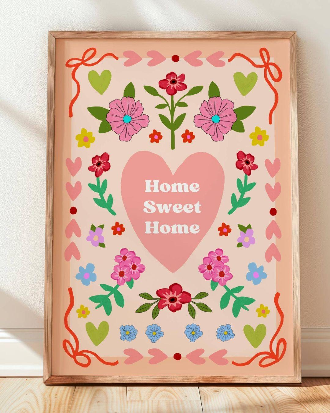 Decorative wall art with 'Home Sweet Home' text and floral designs on a peach background.