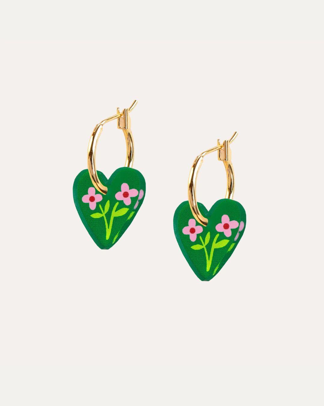 Pair of green and god heart gold hoop earrings with flowers on a white background