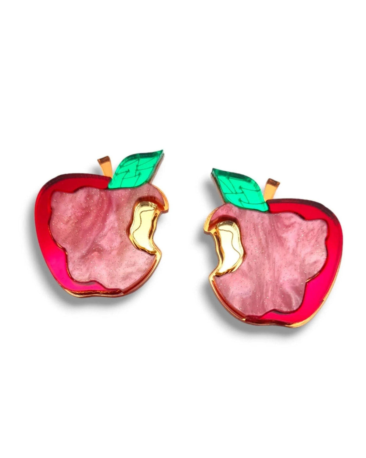 A pair of apple-shaped earrings with a glossy pink inner fill, a bright red outer border, gold-tone outlines and stem details, and green leaves, shown on a plain white background.