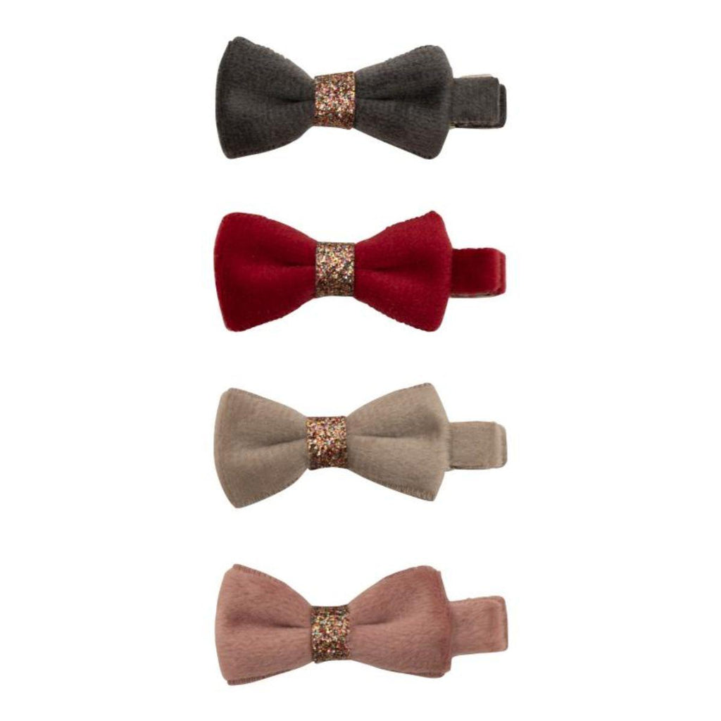 Four velvet bow clips in different colors on a white background