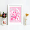 Framed pink art print with white animal illustrations on a white surface with decorative items.