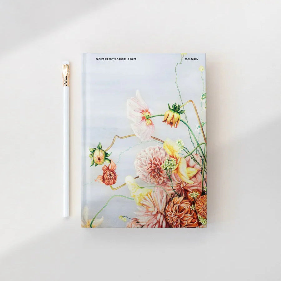 Floral notebook with a gold zipper on a white background