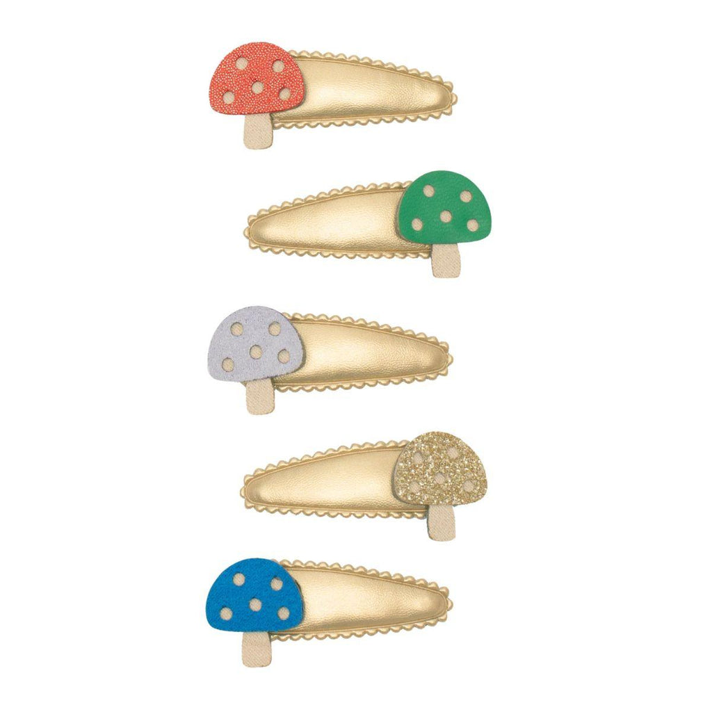 Set of five gold hair clips with colorful mushroom designs on a white background
