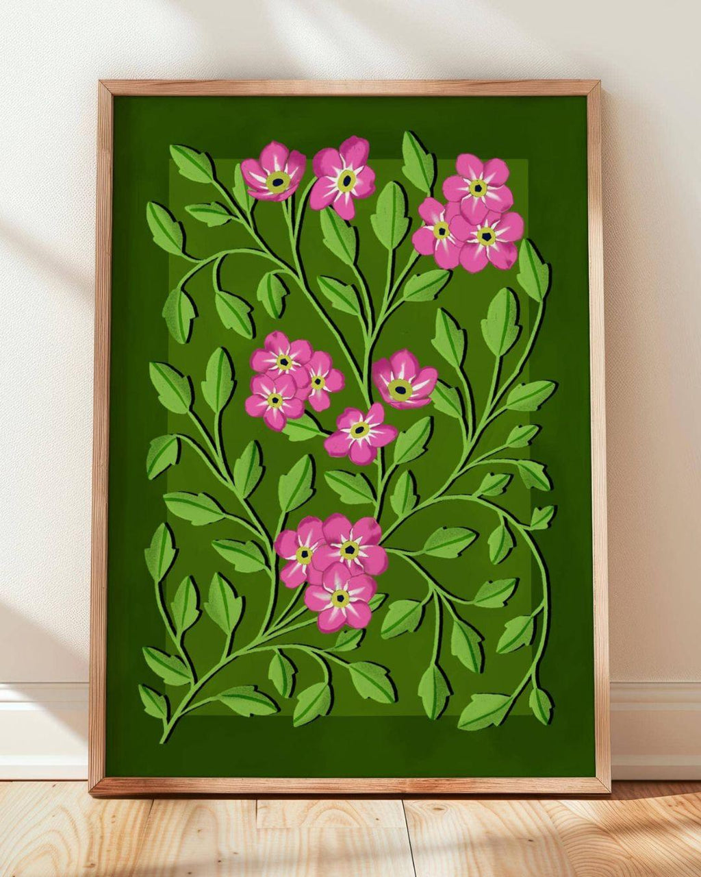 Framed artwork with pink flowers and green leaves on a green background