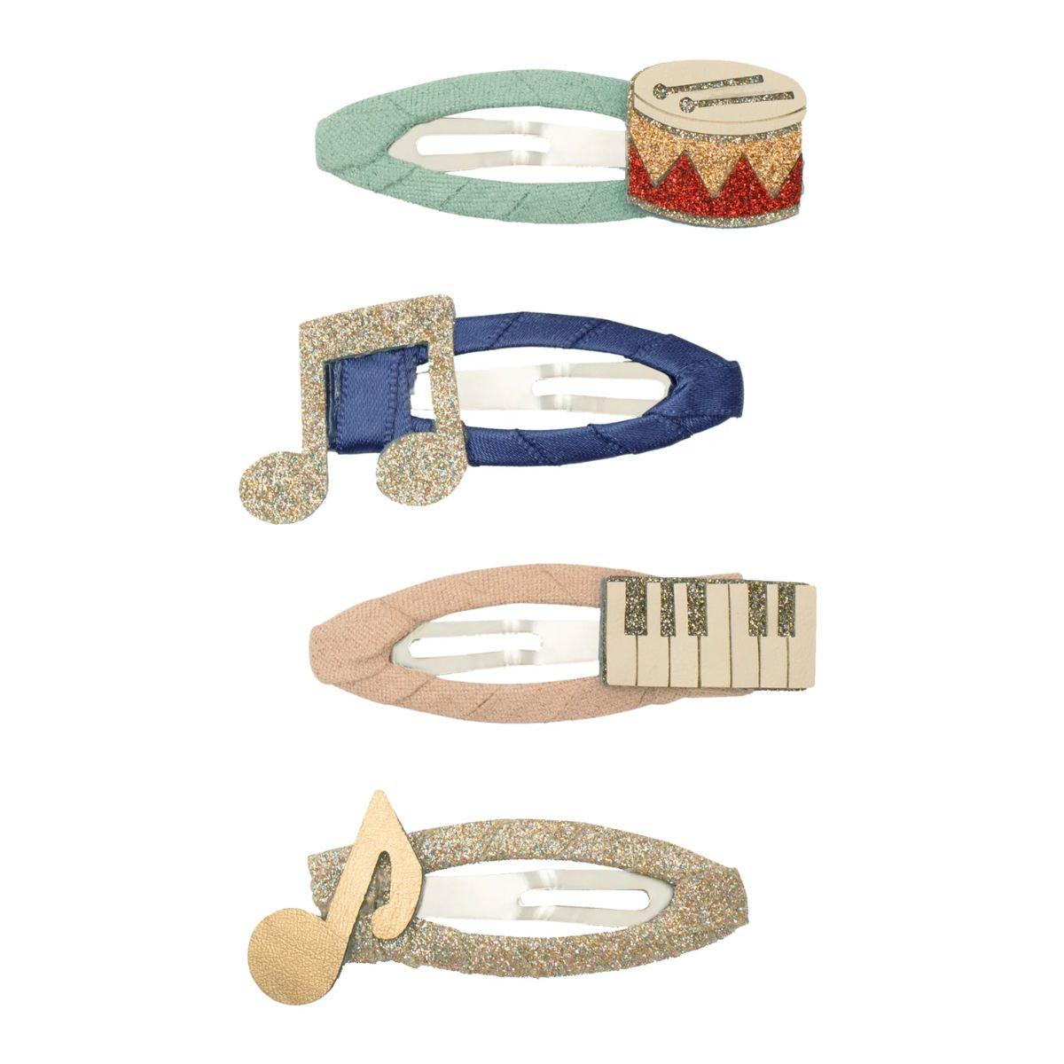 Set of five decorative hair clips with musical note designs on a white background