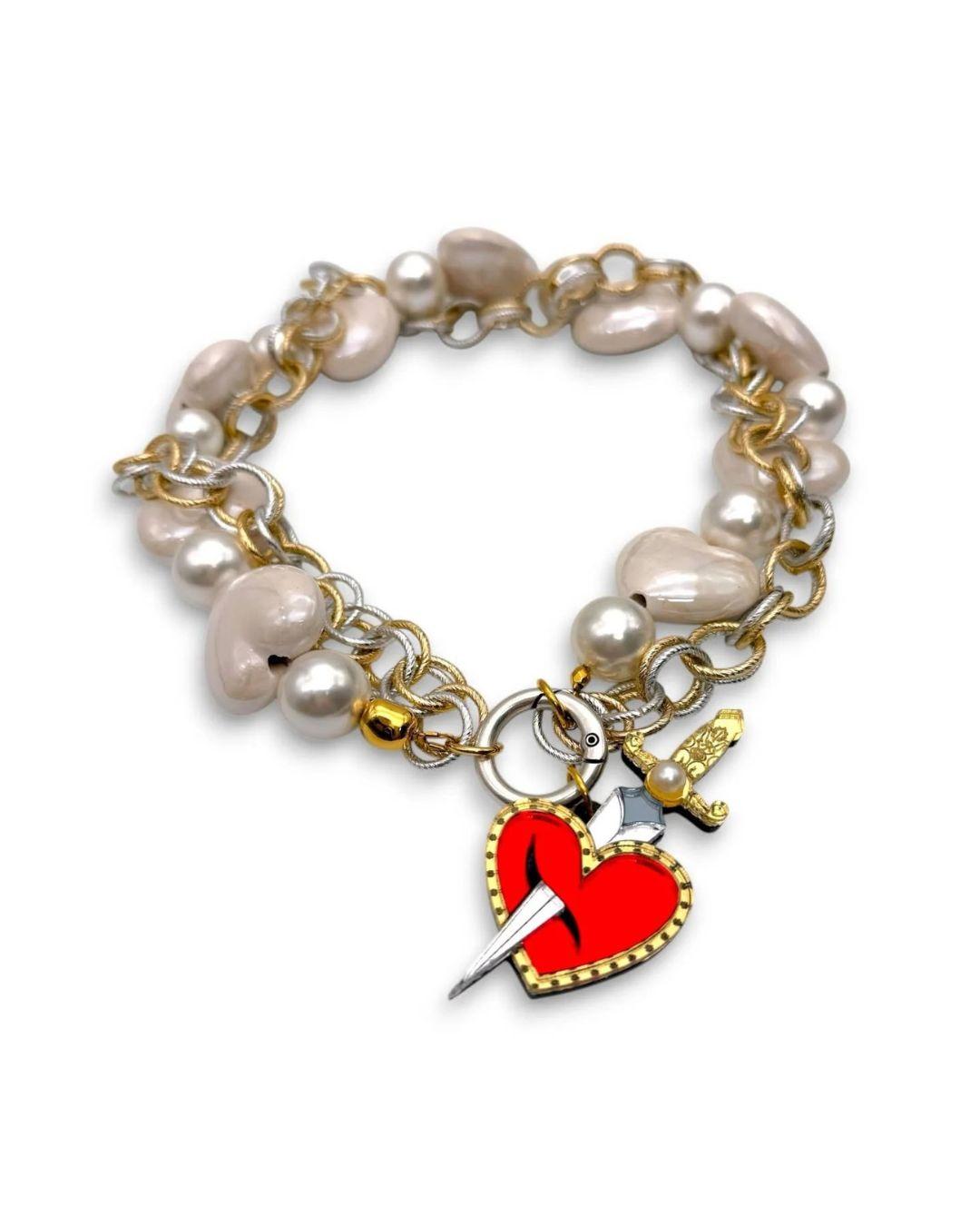 Necklace with pearl beads and heart-shaped charm on a white background