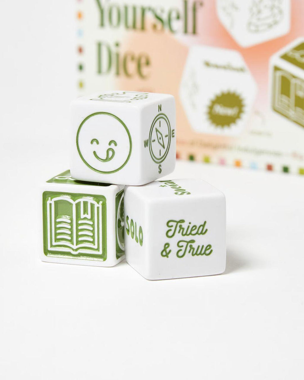White dice with green text and symbols on a white background