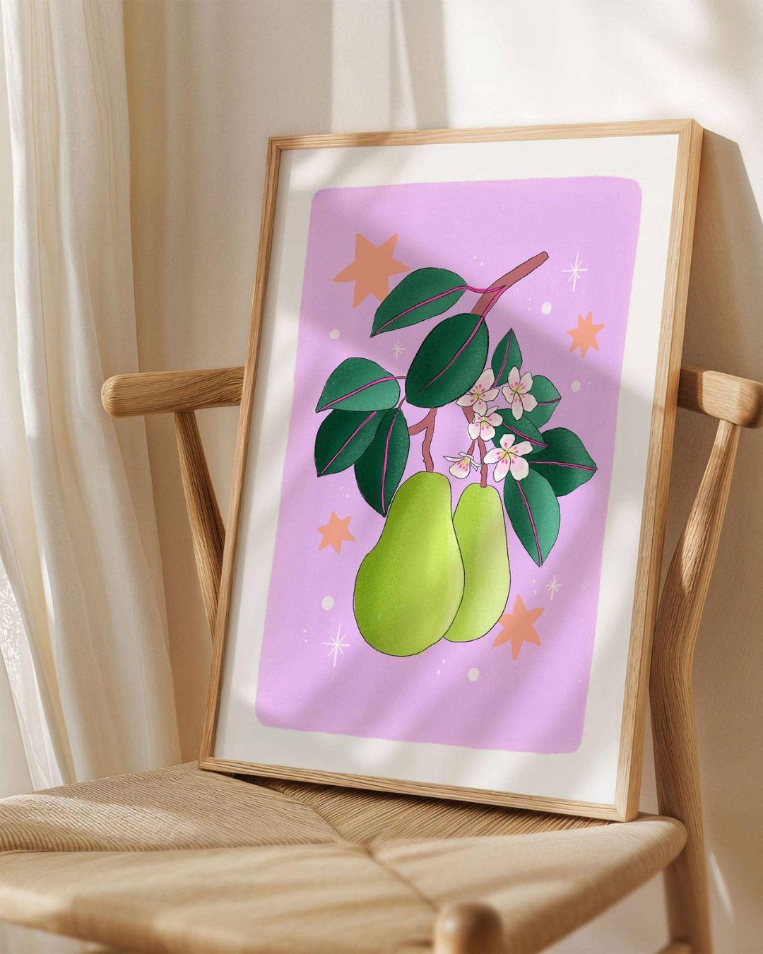 Framed artwork of pears and leaves on a chair with a light background