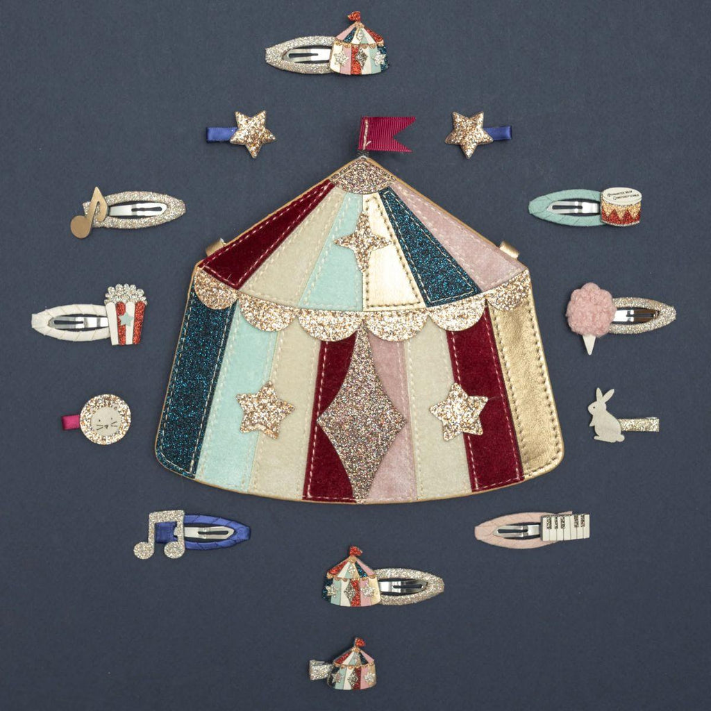 Colorful circus-themed hair clip set on a dark blue background