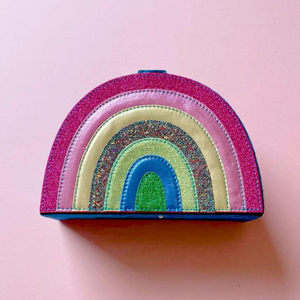 Colorful rainbow-shaped pouch on a pink background