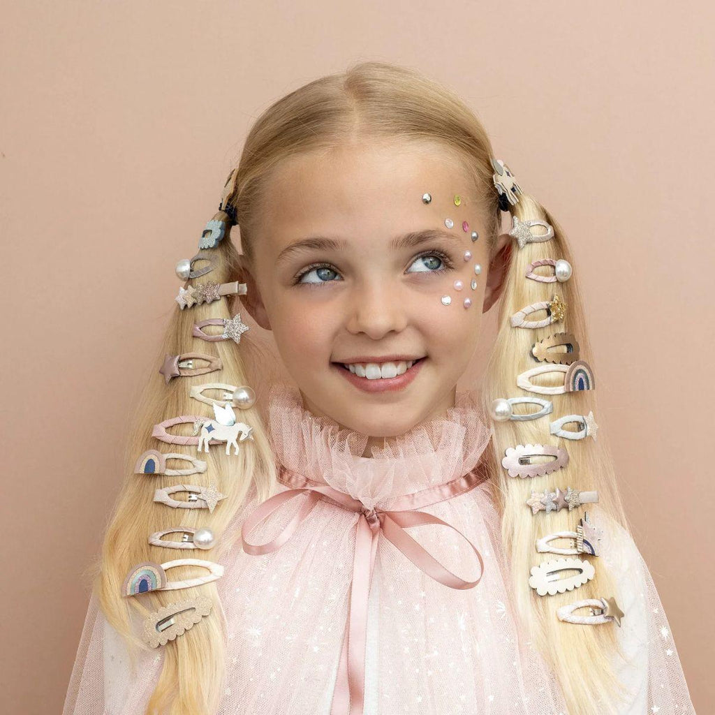 Young girl with decorative hair clips on a beige background