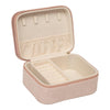 Pink jewelry box with beige interior on a white background