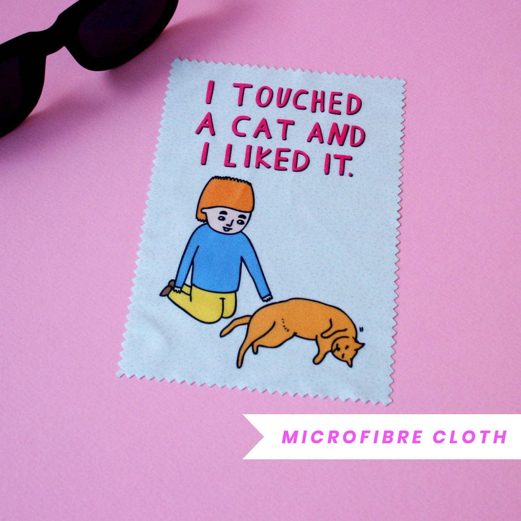 Microfibre cloth with a cartoon design of a boy and cat, text 'I touched a cat and I liked it.' on a pink background.