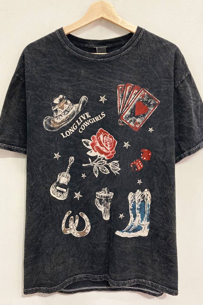 Black t-shirt with cowboy-themed graphics on a wooden hanger against a white background