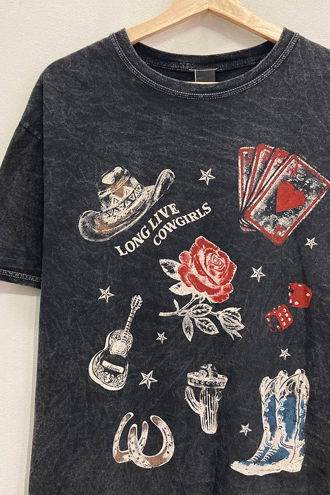 Black t-shirt with cowboy-themed graphics on a wooden hanger.
