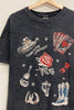 Black t-shirt with cowboy-themed graphics on a wooden hanger.