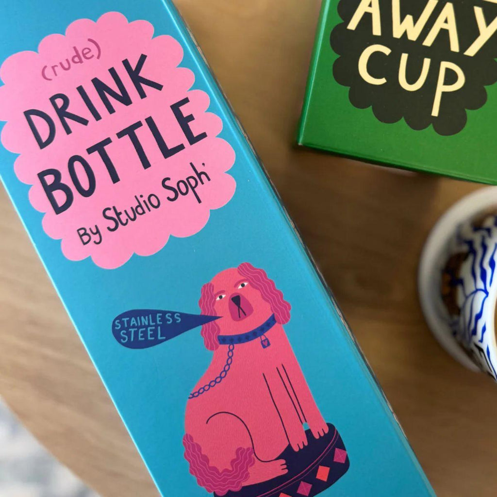 Box of a drink bottle with a dog illustration on a wooden surface
