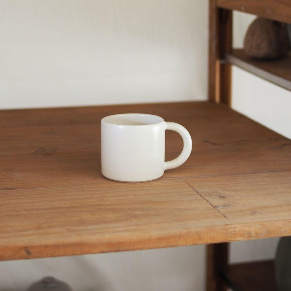 White mug on a wooden table with a blurred background