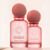 Two pink perfume bottles with 'evaliah' branding on a light background