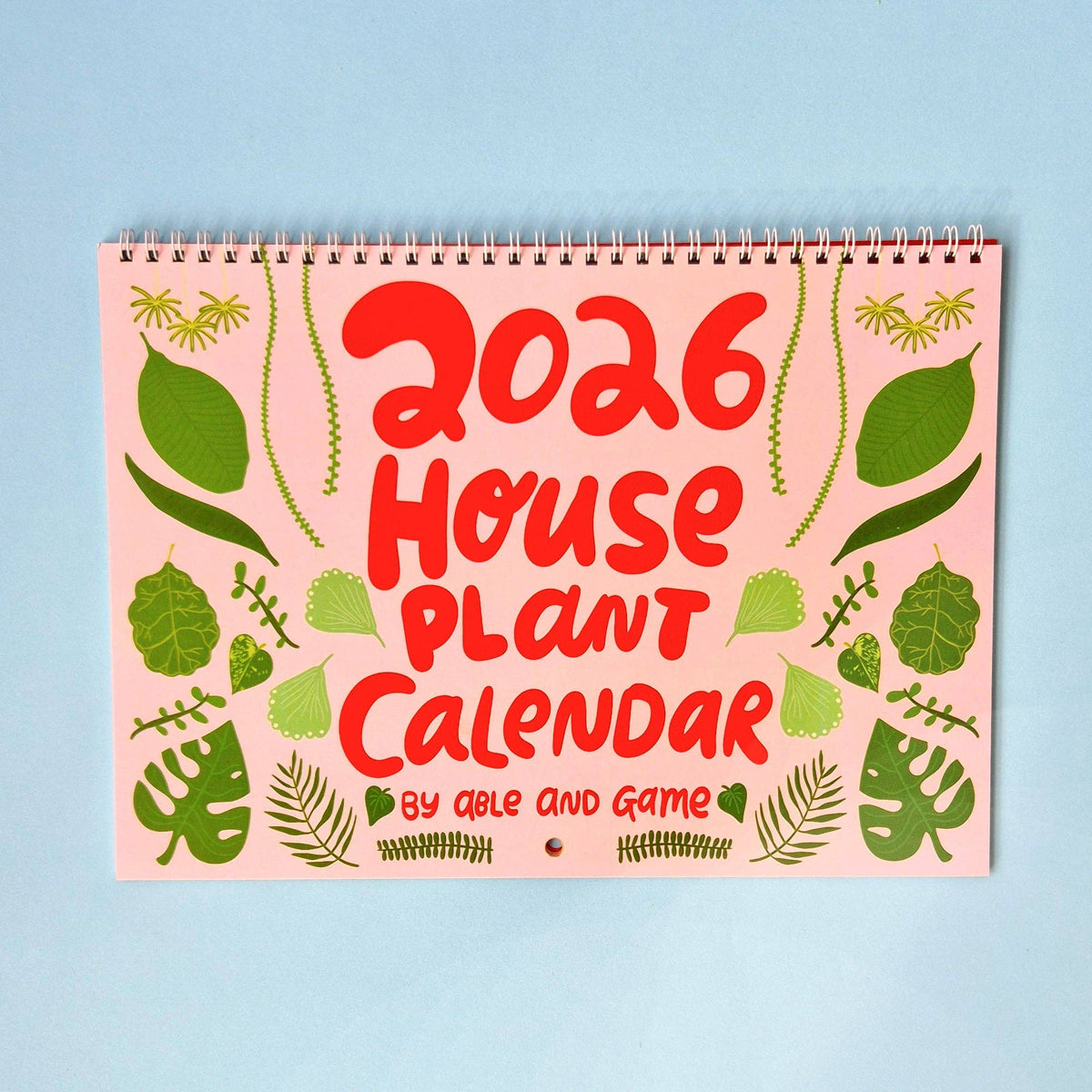 2026 House Plant Calendar with green leaf patterns on a pink background