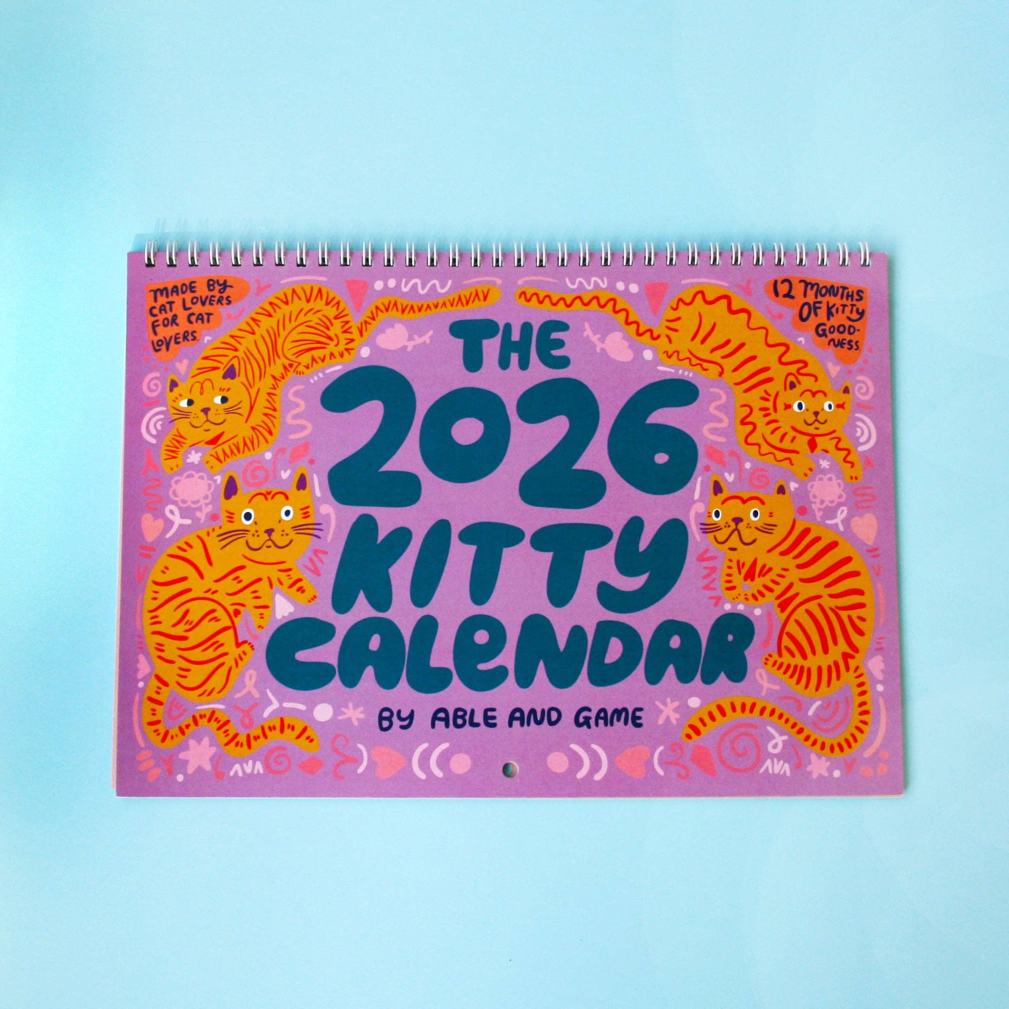 2026 Kitty Calendar with colorful cat illustrations on a light blue background
