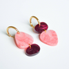 Pair of pink and purple earrings with gold hooks on a white background