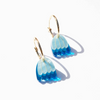Blue floral earrings with gold accents on a white background